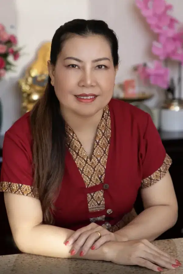 Senior massage therapist Danni smiling at the reception desk of Blue Diamond Thai Spa & Massage