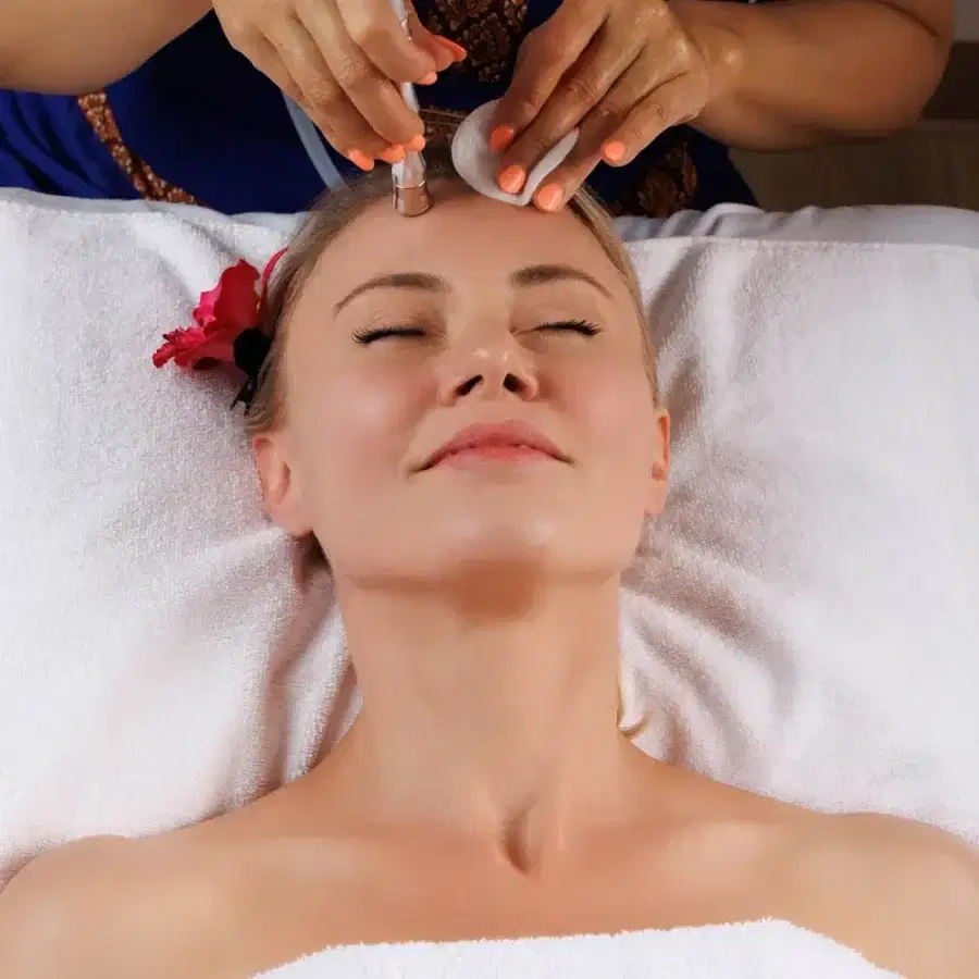 A client receiving a professional facial treatment at Blue Diamond Thai Spa